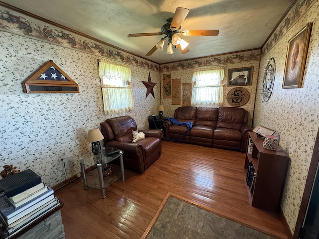 living room with ceiling fan, crown molding, and dark wood-type flooring