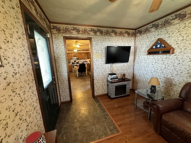 living room featuring dark hardwood / wood-style floors, a fireplace, and crown molding