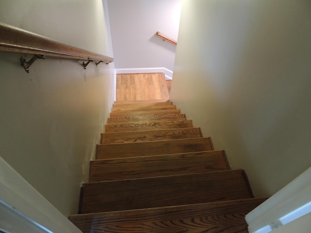 staircase with hardwood / wood-style floors