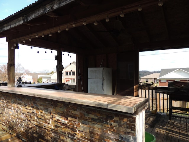 view of patio featuring exterior bar and a deck