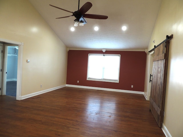 unfurnished room featuring ceiling fan, a barn door, dark hardwood / wood-style floors, and high vaulted ceiling