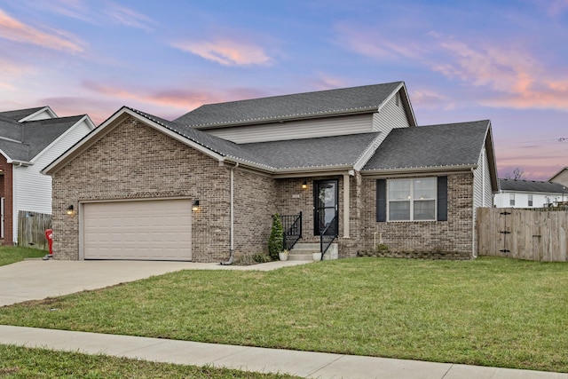 view of front of home with a lawn and a garage