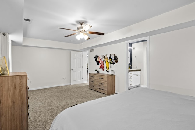 carpeted bedroom featuring ensuite bath and ceiling fan