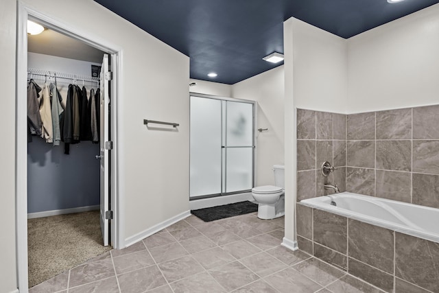 bathroom with tile patterned floors, shower with separate bathtub, and toilet