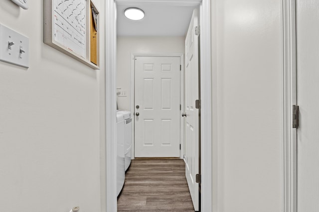 corridor featuring hardwood / wood-style floors and washing machine and clothes dryer