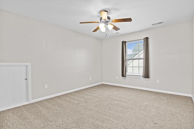 empty room with ceiling fan and carpet floors