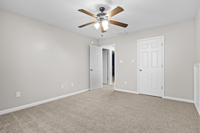 unfurnished bedroom featuring ceiling fan and carpet