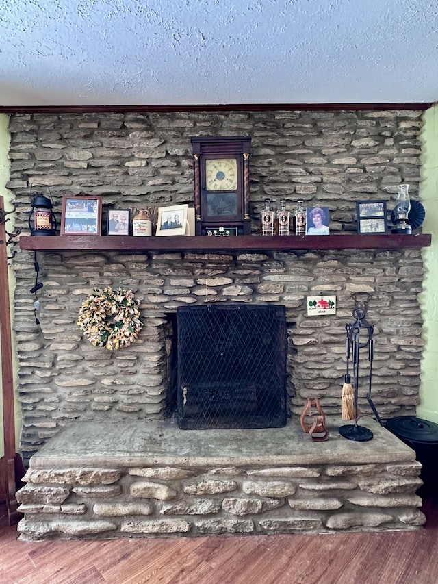 interior details featuring hardwood / wood-style flooring and a textured ceiling