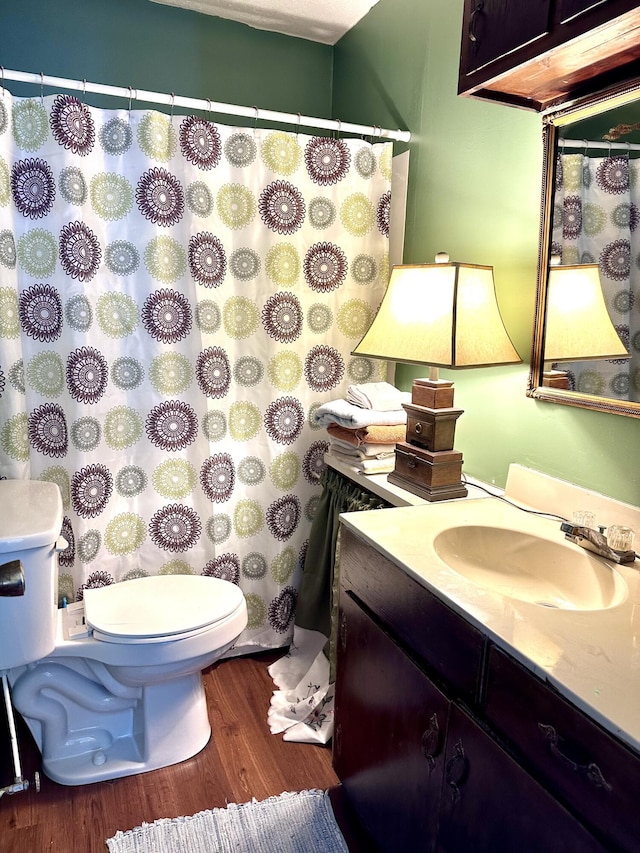 bathroom featuring hardwood / wood-style flooring, vanity, and toilet