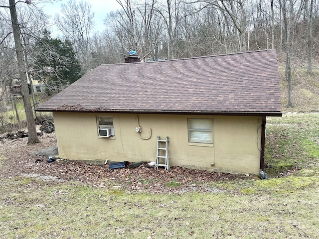 view of side of home featuring a yard and cooling unit