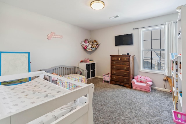 carpeted bedroom with a nursery area