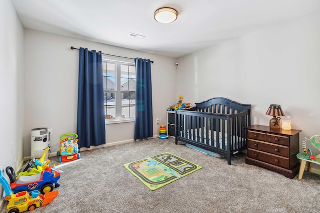 carpeted bedroom featuring a crib