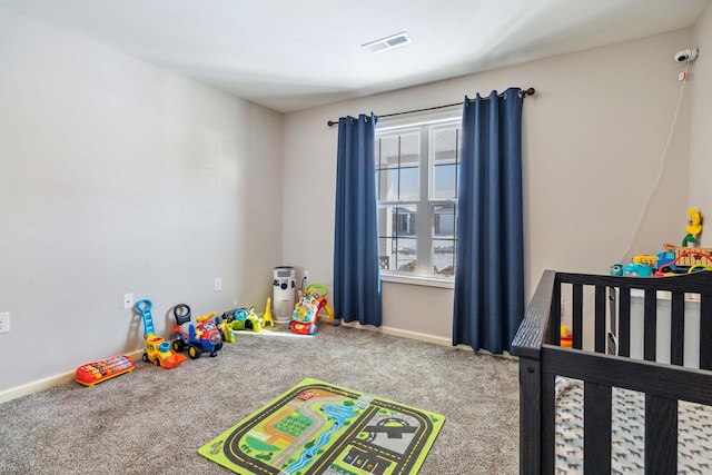 bedroom with carpet and a crib