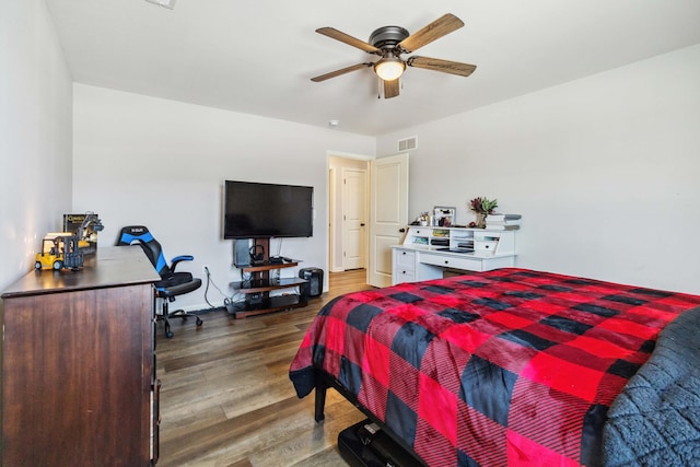 bedroom with dark hardwood / wood-style floors and ceiling fan