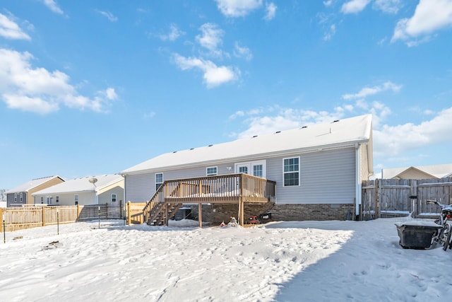 snow covered property featuring a wooden deck