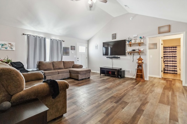 living room featuring ceiling fan, hardwood / wood-style floors, and lofted ceiling