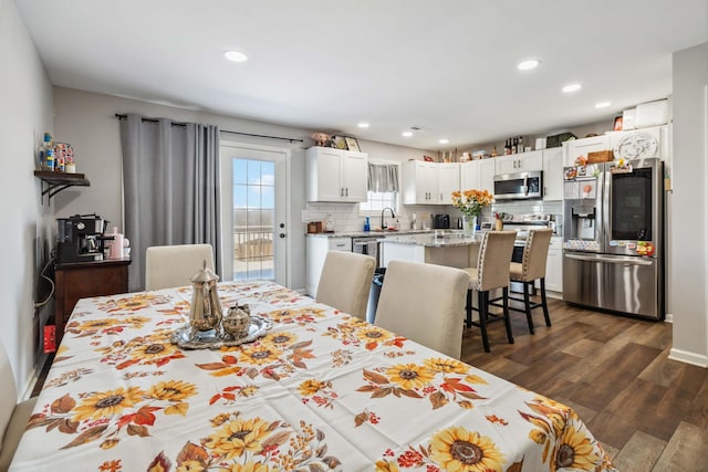 dining area featuring dark hardwood / wood-style flooring and sink