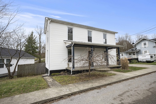 view of front of house with fence and a porch