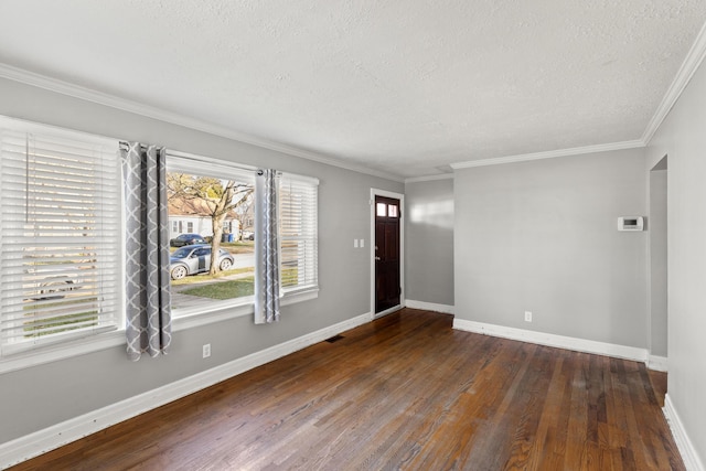 interior space with a textured ceiling, ornamental molding, and dark wood-type flooring