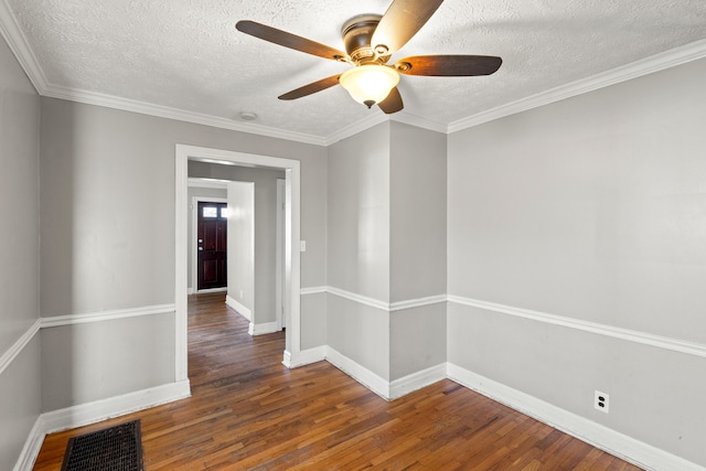 unfurnished room with ceiling fan, dark hardwood / wood-style flooring, a textured ceiling, and ornamental molding