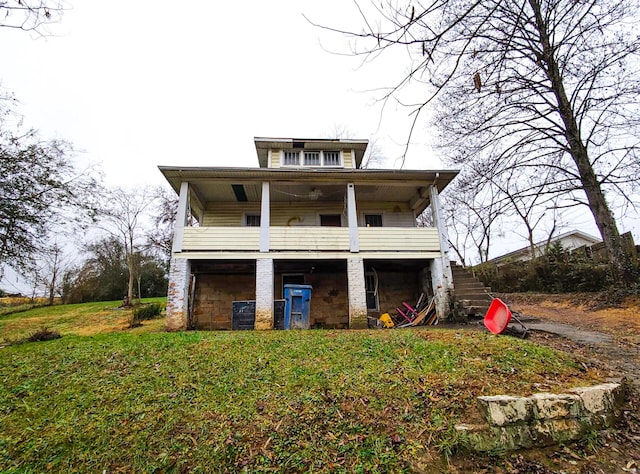 view of front of home featuring a balcony and a front lawn