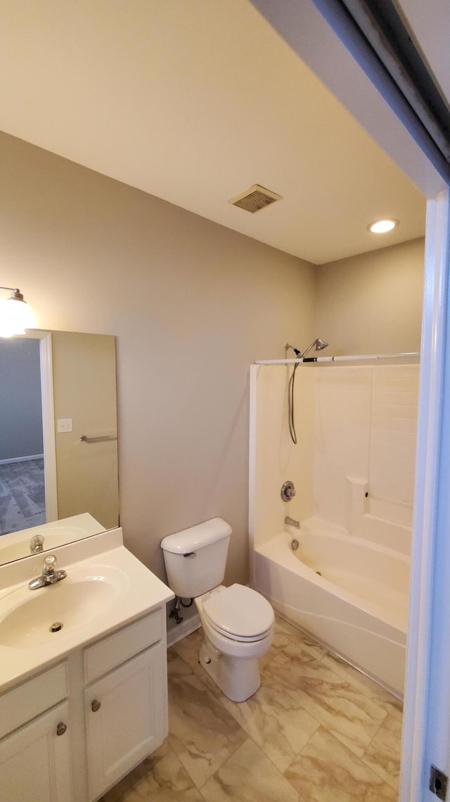 full bathroom with visible vents, toilet, marble finish floor, shower / washtub combination, and vanity