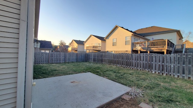 view of yard with a residential view, a patio, and a fenced backyard