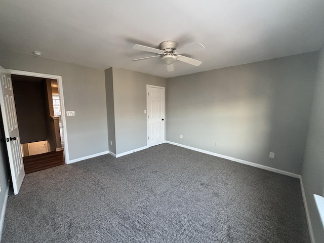 unfurnished bedroom with ceiling fan and dark colored carpet