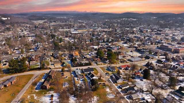 aerial view at dusk featuring a mountain view