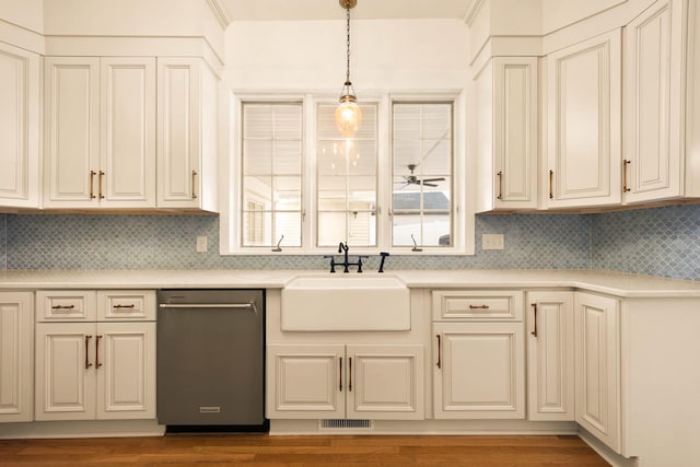 kitchen with ceiling fan, dishwasher, sink, backsplash, and decorative light fixtures