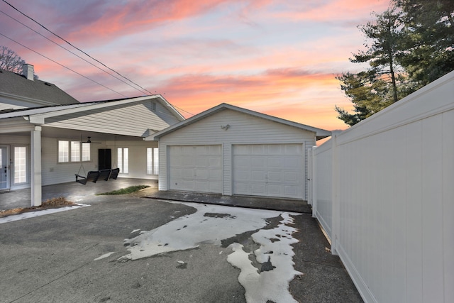 garage at dusk with covered porch