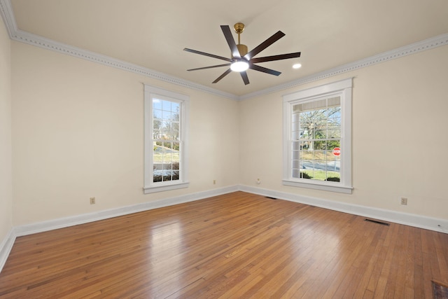 unfurnished room with hardwood / wood-style floors, ceiling fan, and crown molding