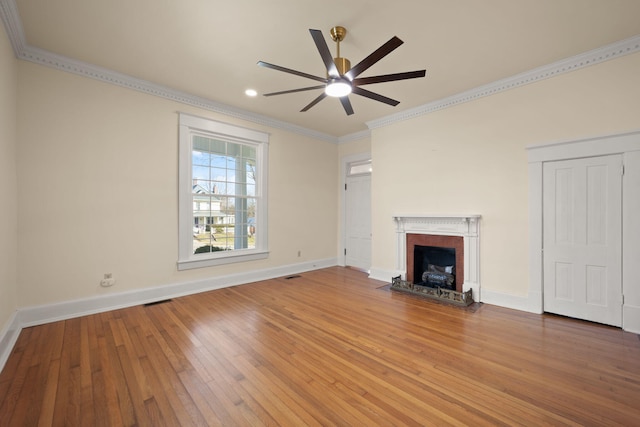 unfurnished living room featuring a fireplace, hardwood / wood-style flooring, ceiling fan, and ornamental molding