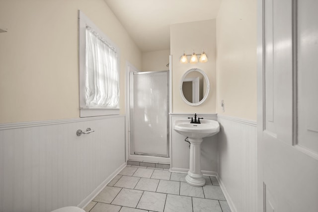 bathroom featuring tile patterned flooring and a shower with shower door