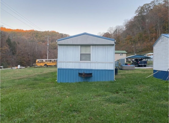 view of outbuilding featuring a lawn