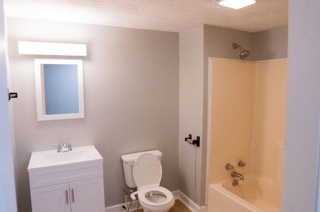 full bathroom featuring washtub / shower combination, a textured ceiling, vanity, and toilet