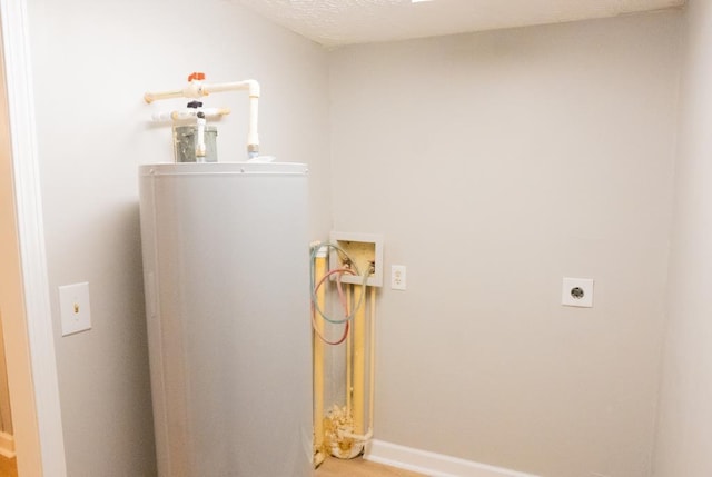 interior space featuring electric dryer hookup, a textured ceiling, and hookup for a washing machine