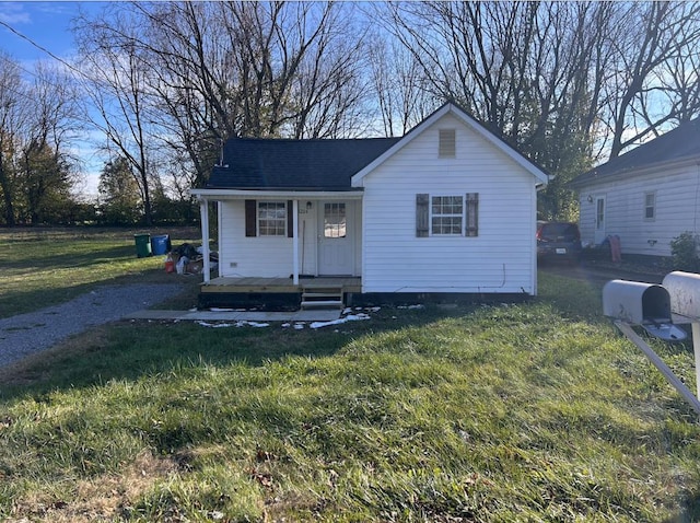 view of front of property with covered porch and a front yard