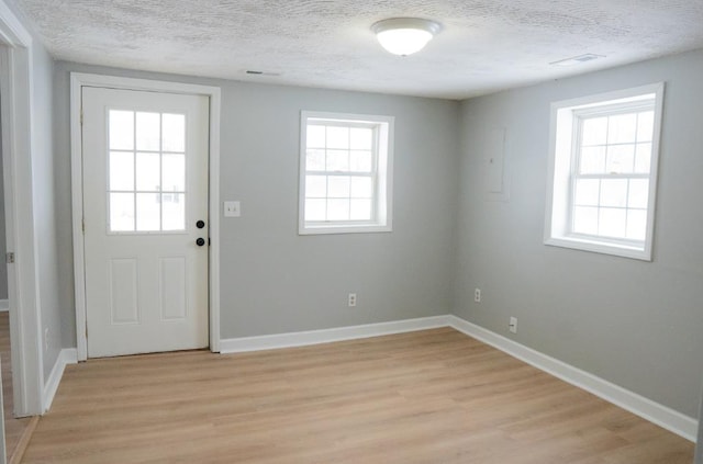 entryway with a healthy amount of sunlight and a textured ceiling