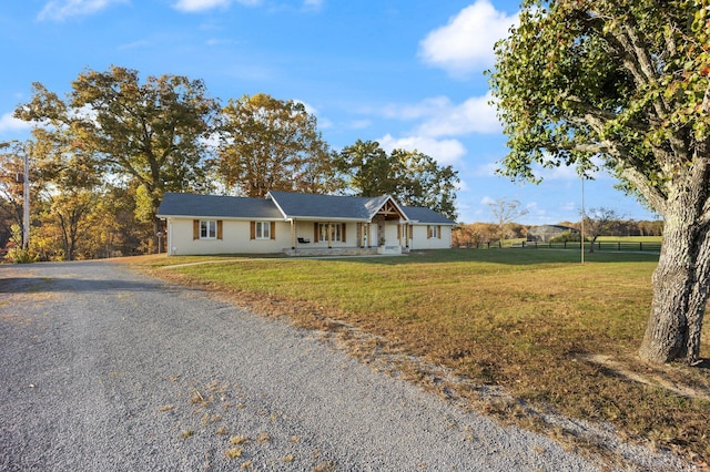 ranch-style home featuring a porch and a front yard