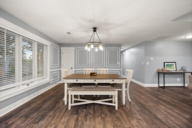 dining area with a notable chandelier and dark wood-type flooring