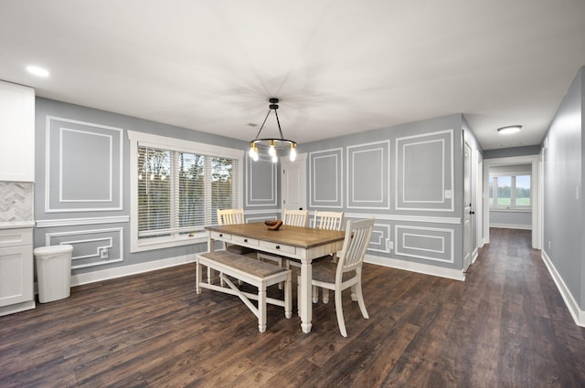 dining space with a chandelier and dark hardwood / wood-style floors