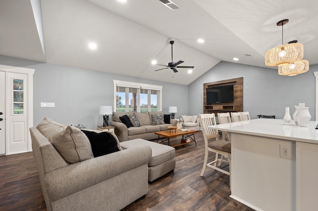 living room featuring dark hardwood / wood-style floors, vaulted ceiling, and ceiling fan