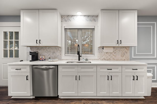 kitchen featuring dishwasher, sink, tasteful backsplash, dark hardwood / wood-style flooring, and white cabinetry