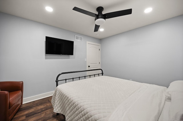 bedroom with ceiling fan and dark hardwood / wood-style flooring