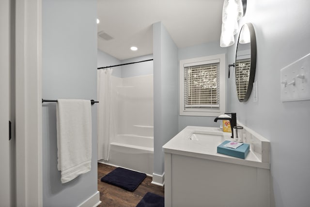 bathroom with vanity, wood-type flooring, and shower / bath combo