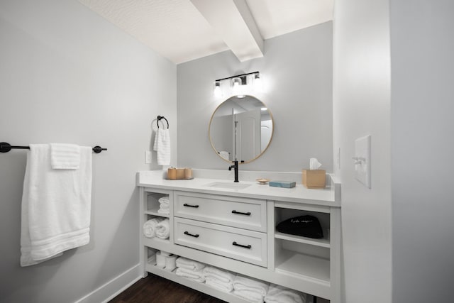 bathroom featuring hardwood / wood-style flooring, vanity, and a textured ceiling