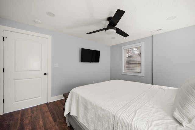 bedroom featuring dark hardwood / wood-style floors and ceiling fan