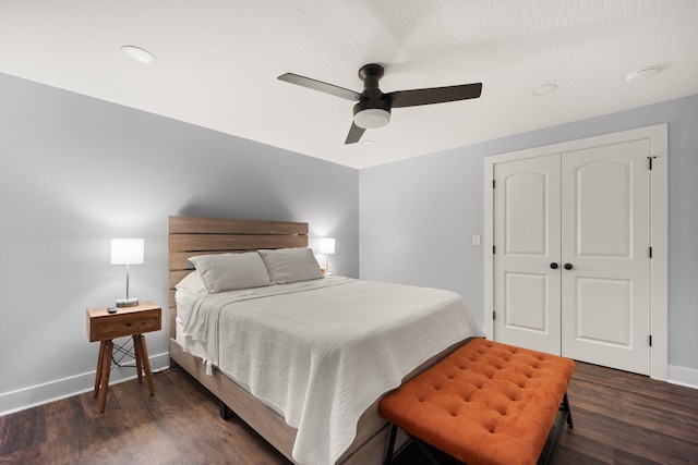 bedroom with ceiling fan, dark hardwood / wood-style flooring, and a closet