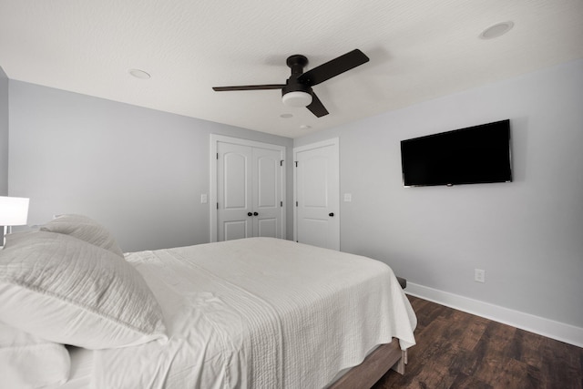 bedroom with a closet, ceiling fan, and dark wood-type flooring